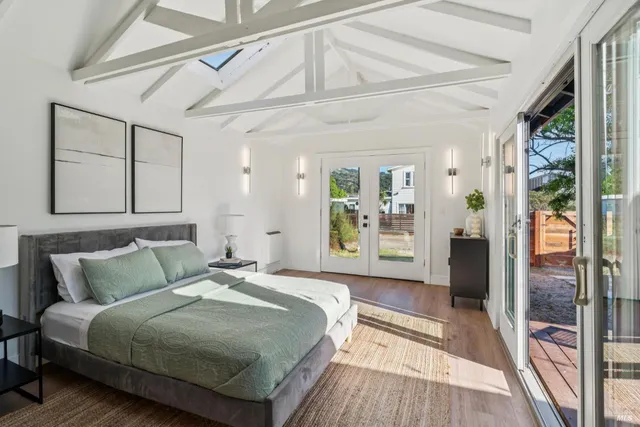 a spacious bedroom with a bed and a large window