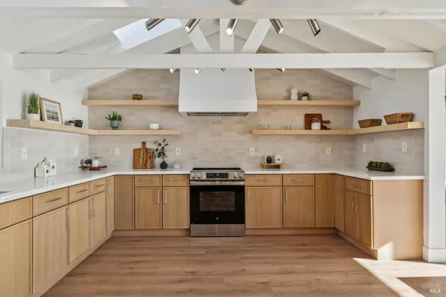 a kitchen with stainless steel appliances granite countertop a sink and stove top oven