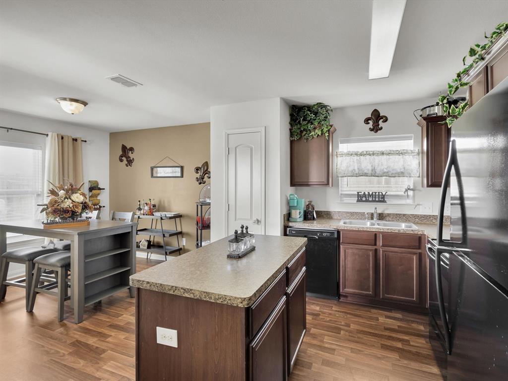 1808 Douglas Street Howe, TX 75459 - Photo 12 of 37 a kitchen with a stove sink and cabinets