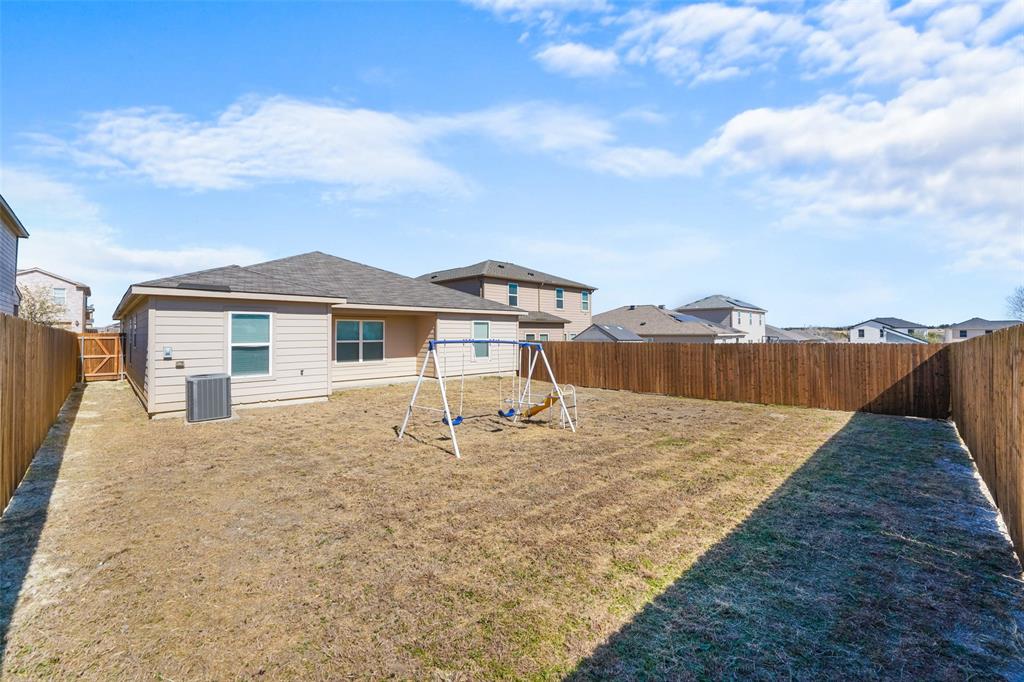 1808 Douglas Street Howe, TX 75459 - Photo 34 of 37 a white house with a yard and wooden fence