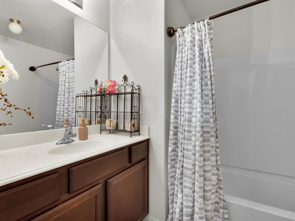 1808 Douglas Street Howe, TX 75459 - Photo 5 of 37 a bathroom with a sink and a mirror
