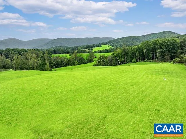 a view of a big yard with a large mountain