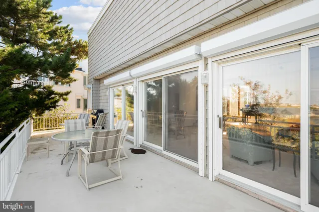 a bathroom with a granite countertop toilet a sink and a mirror