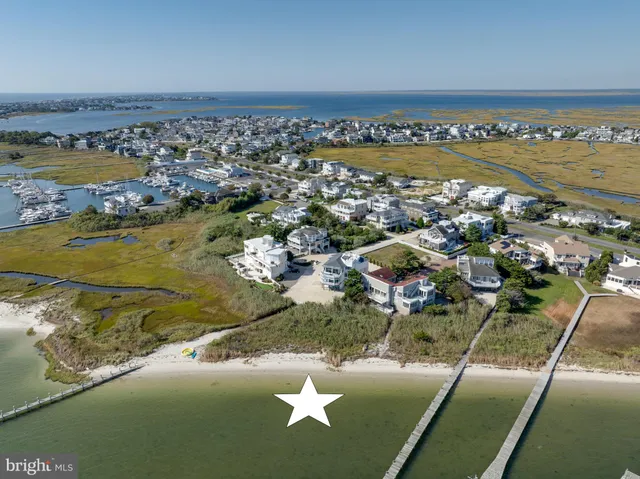 an aerial view of a house with a ocean