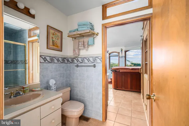 a bathroom with a tub sink and mirror