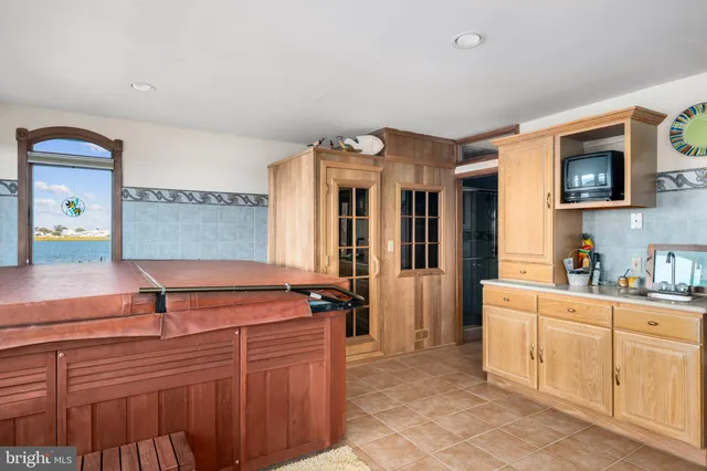 a bedroom with furniture and a large window