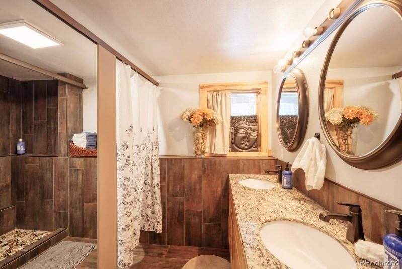 106 Protector Circle Breckenridge, CO 80424 - Photo 18 of 40 a bathroom with a granite countertop sink mirror and vanity