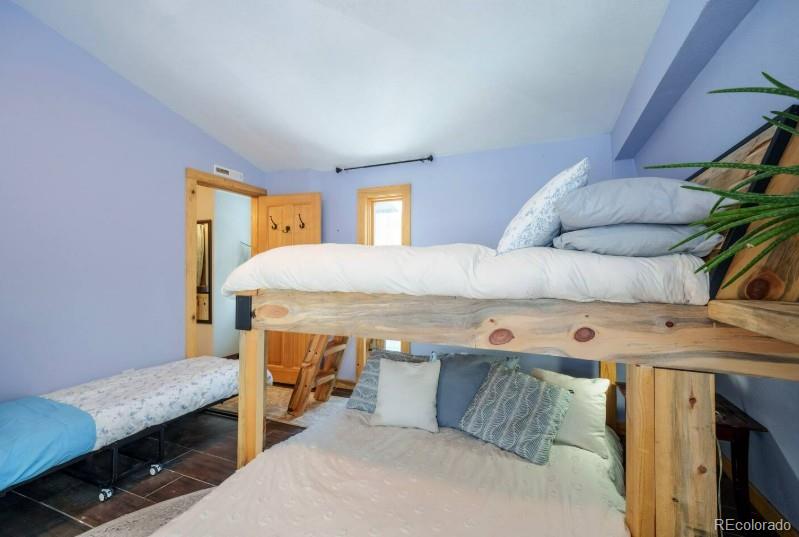 106 Protector Circle Breckenridge, CO 80424 - Photo 22 of 40 a bedroom with a bed and a desk