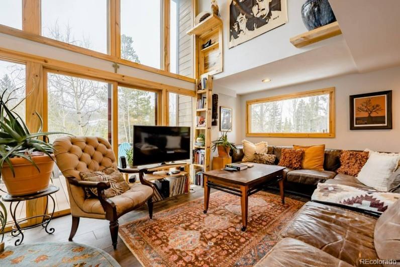 106 Protector Circle Breckenridge, CO 80424 - Photo 3 of 40 a living room with furniture a flat screen tv and a large window