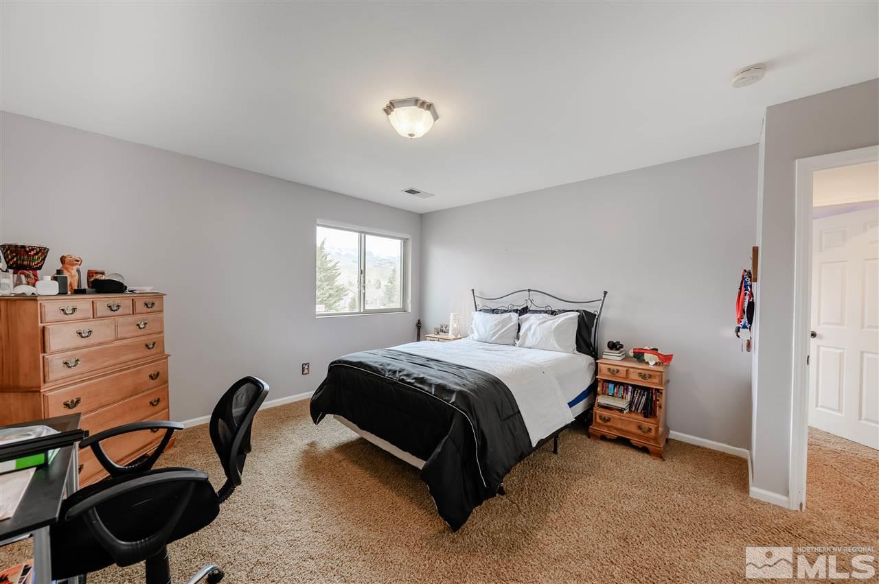10300 Silva Ranch Road Reno, NV 89523 - Photo 13 of 25 a spacious bedroom with a bed and a cabinets