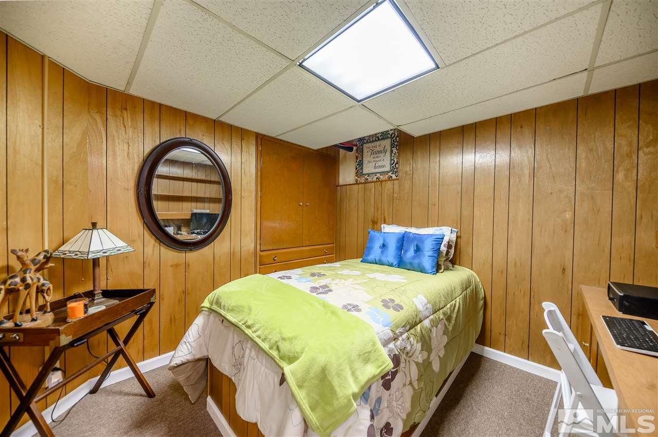 10300 Silva Ranch Road Reno, NV 89523 - Photo 18 of 25 a bedroom with a bed a mirror on the dresser and floor