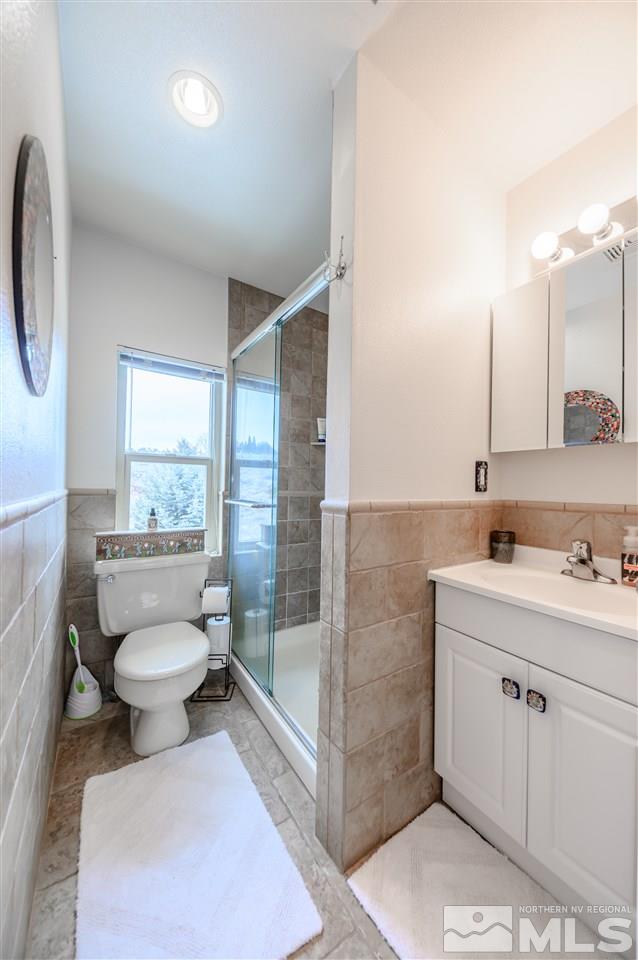 10300 Silva Ranch Road Reno, NV 89523 - Photo 23 of 25 a bathroom with a toilet sink and mirror