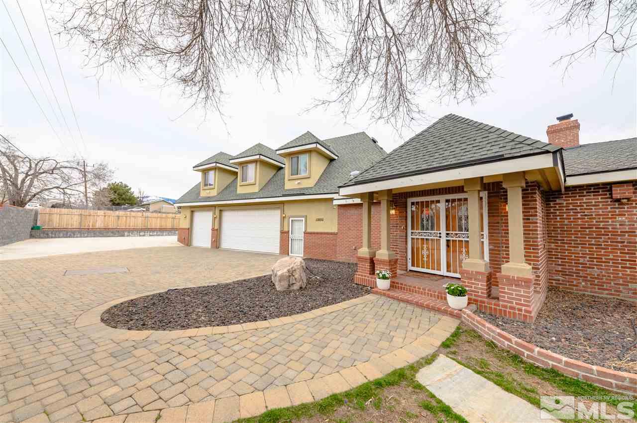 10300 Silva Ranch Road Reno, NV 89523 - Photo 24 of 25 a front view of a house with a yard and garage