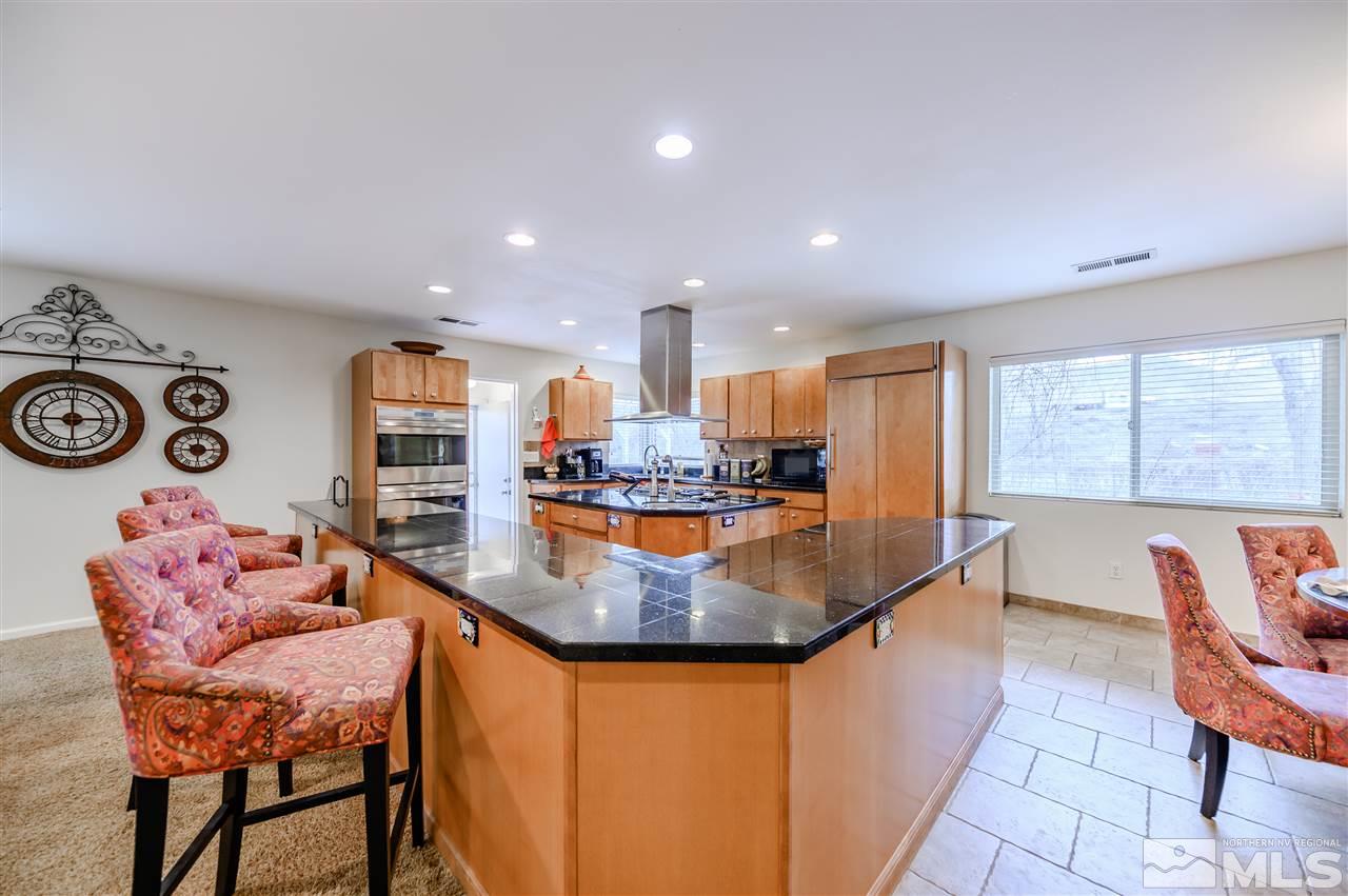 10300 Silva Ranch Road Reno, NV 89523 - Photo 5 of 25 a kitchen with stainless steel appliances granite countertop a sink and a refrigerator