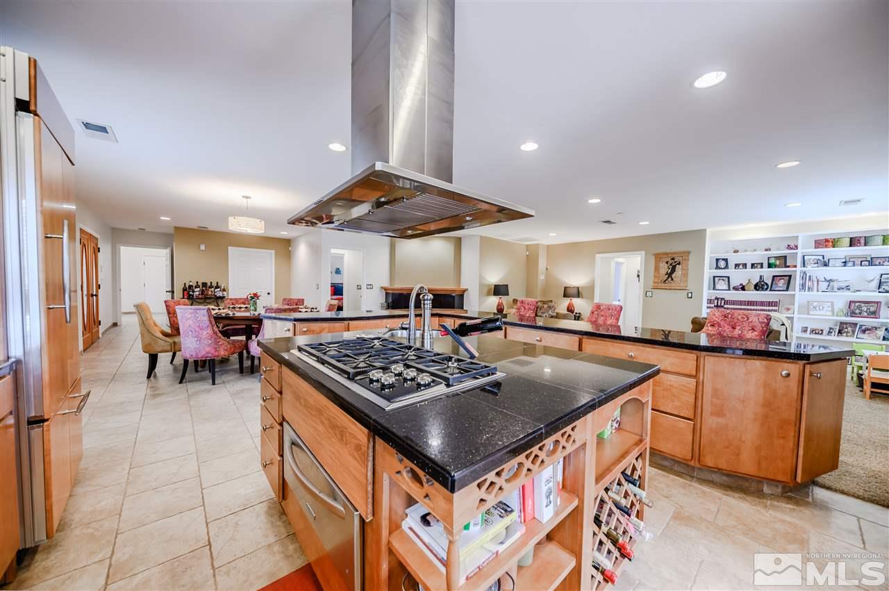 10300 Silva Ranch Road Reno, NV 89523 - Photo 7 of 25 a kitchen with stainless steel appliances granite countertop a stove a sink a counter top space and cabinets