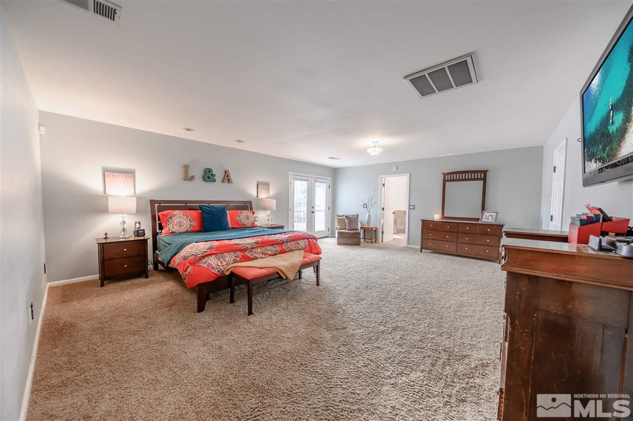 10300 Silva Ranch Road Reno, NV 89523 - Photo 8 of 25 a bedroom with a bed and a flat screen tv