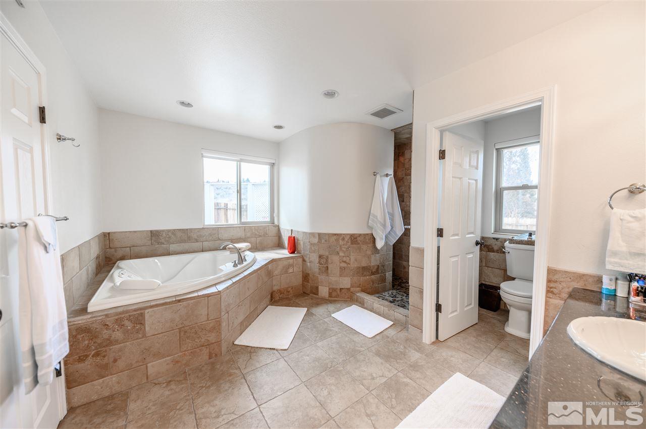 10300 Silva Ranch Road Reno, NV 89523 - Photo 9 of 25 a spacious bathroom with a tub sink and mirror