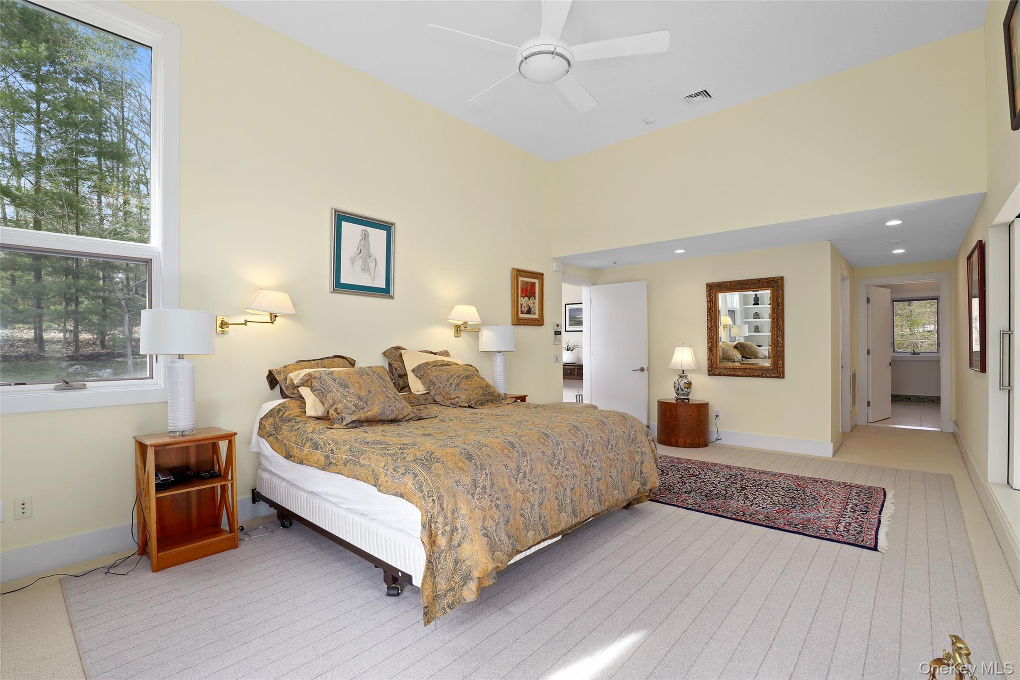 17 Fox Run Road Pound Ridge, NY 10576 - Photo 19 of 30 a bedroom with a bed and a chandelier