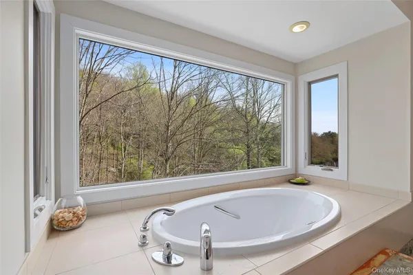 a bath tub sitting in a bathroom next to a window