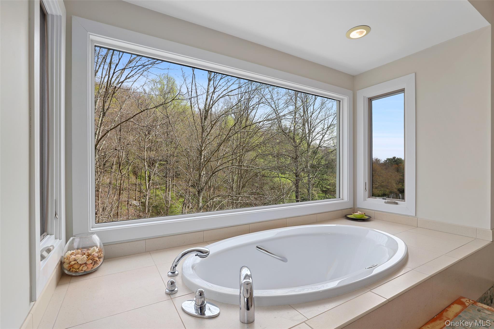 17 Fox Run Road Pound Ridge, NY 10576 - Photo 23 of 30 a bath tub sitting in a bathroom next to a window