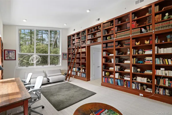 a living room with a bookshelf and a book shelf