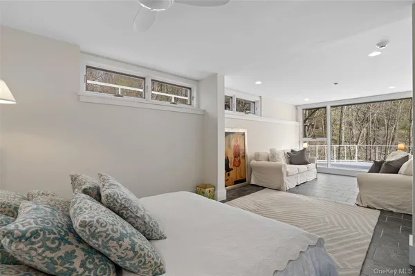 a bedroom with furniture and a large window