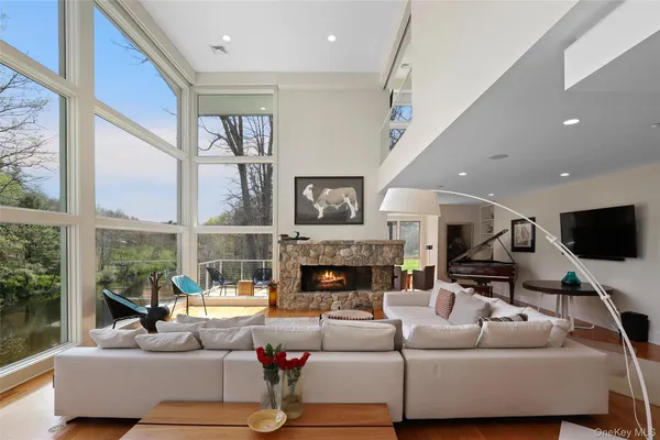a living room with fireplace furniture and a large window