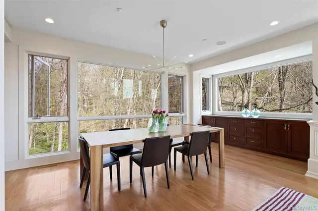 a view of a dining room with furniture window and wooden floor