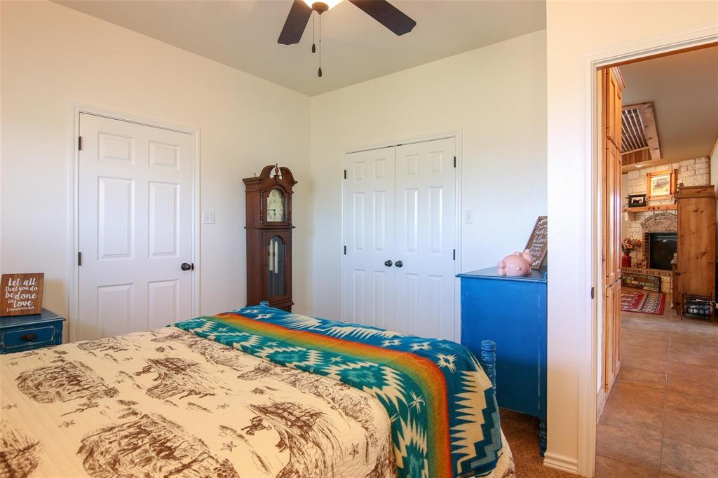7158 Luella Road Sherman, TX 75090 - Photo 16 of 40 a bedroom with a bed and a chandelier