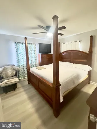 a large white bed sitting in a room next to a window