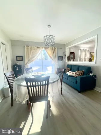 a living room with furniture a table and a chandelier