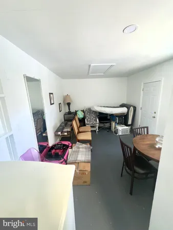 a living room with furniture and next to a window