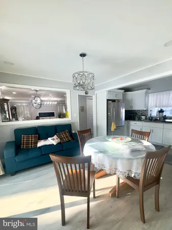 a view of a dining room with furniture and chandelier