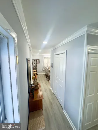 a hallway with a couch and wooden floor