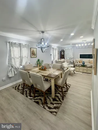 a view of a dining room with furniture and chandelier