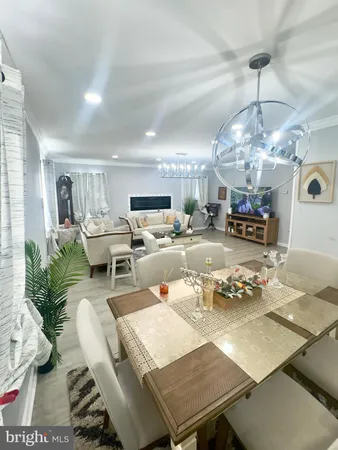 a living room with lots of furniture and chandelier