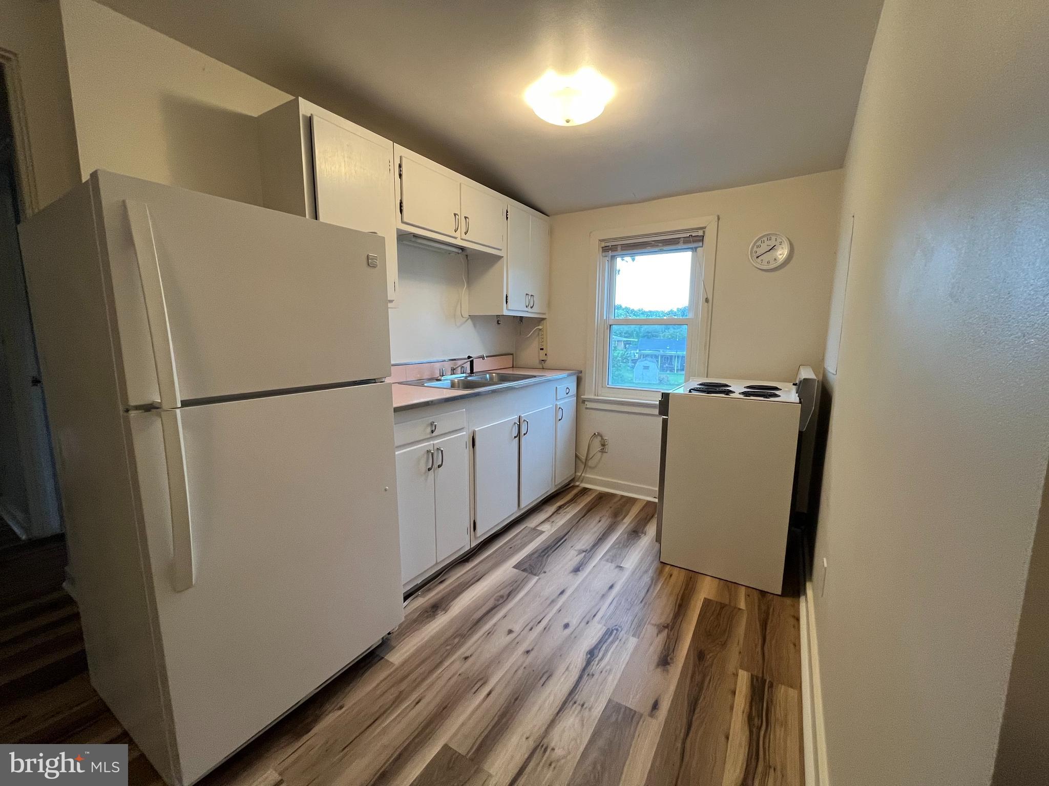 4113 Rosemont Avenue, Unit A Camp Hill, PA 17011 - Photo 2 of 10 a kitchen with wooden cabinets and refrigerator