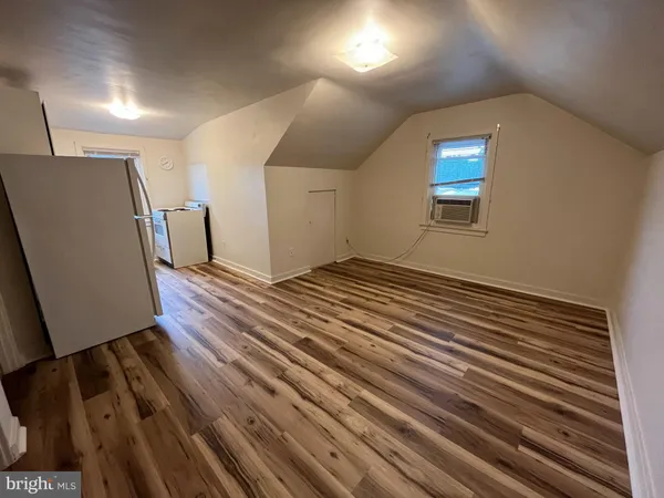 a view of a room with wooden floor