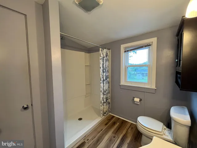 a bathroom with a toilet a sink and shower