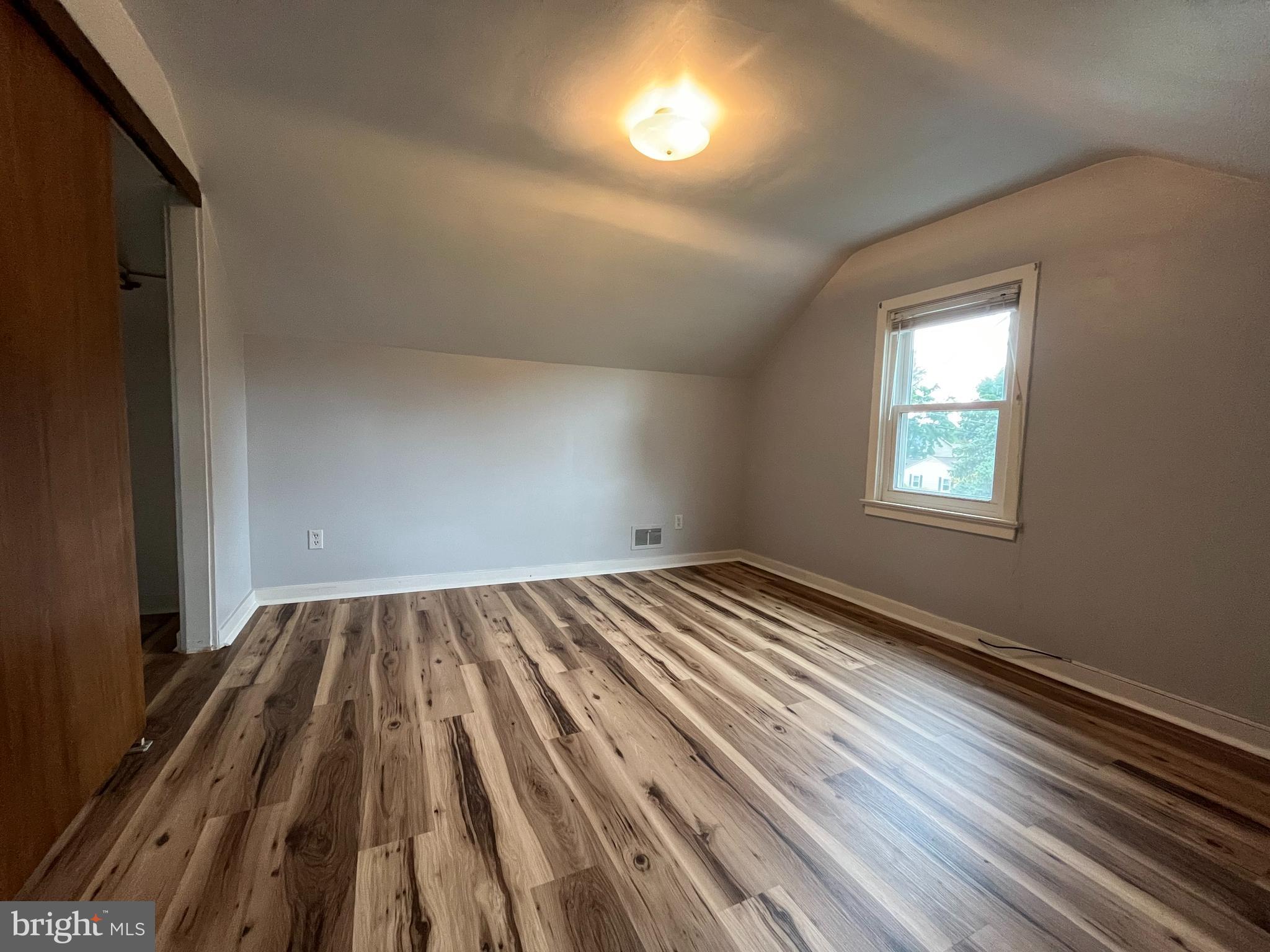 4113 Rosemont Avenue, Unit A Camp Hill, PA 17011 - Photo 8 of 10 wooden floor in an empty room with a window