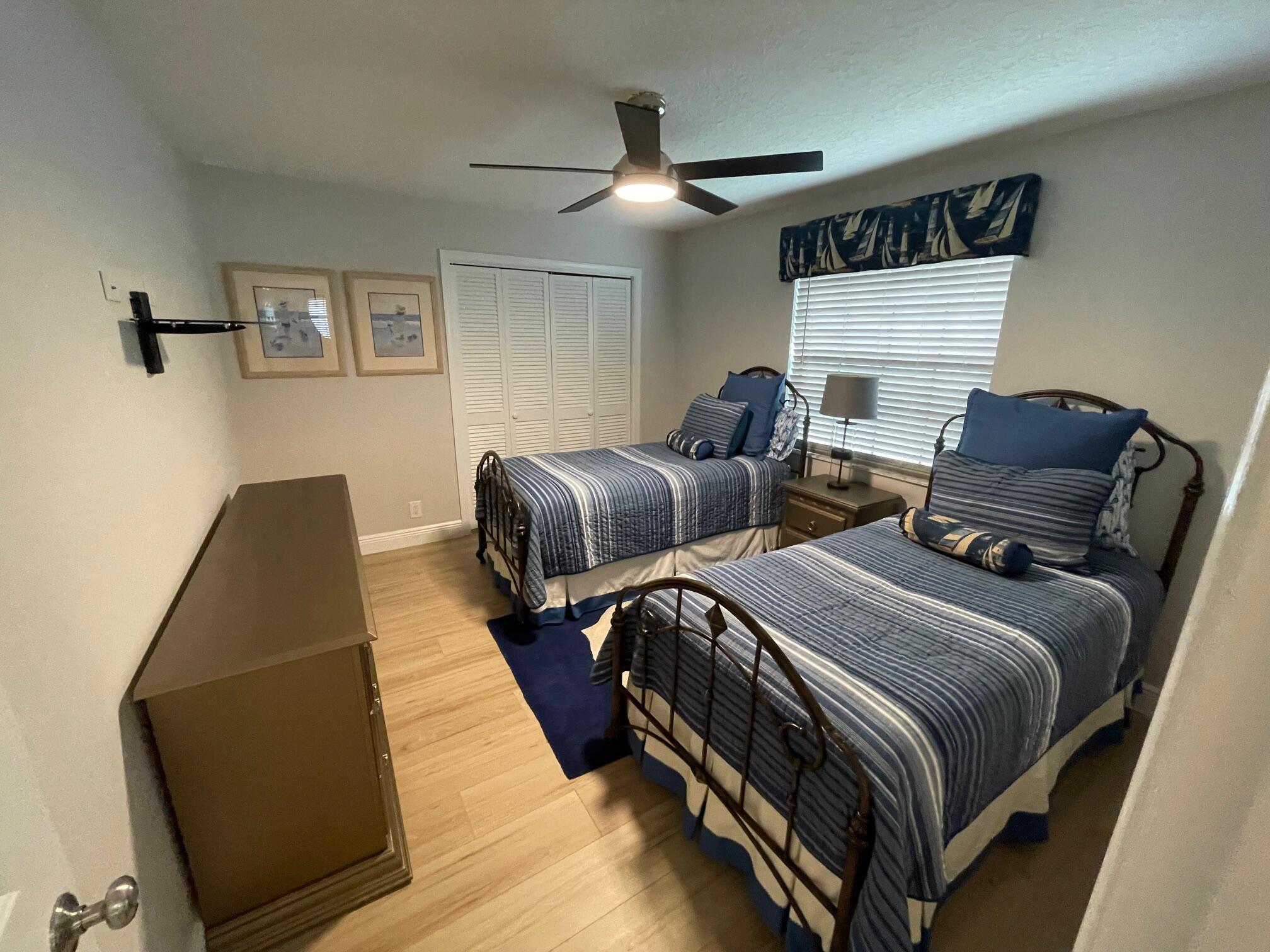 2601 West Carandis Road West Palm Beach, FL 33406 - Photo 10 of 13 a bedroom with two beds and painting on the wall