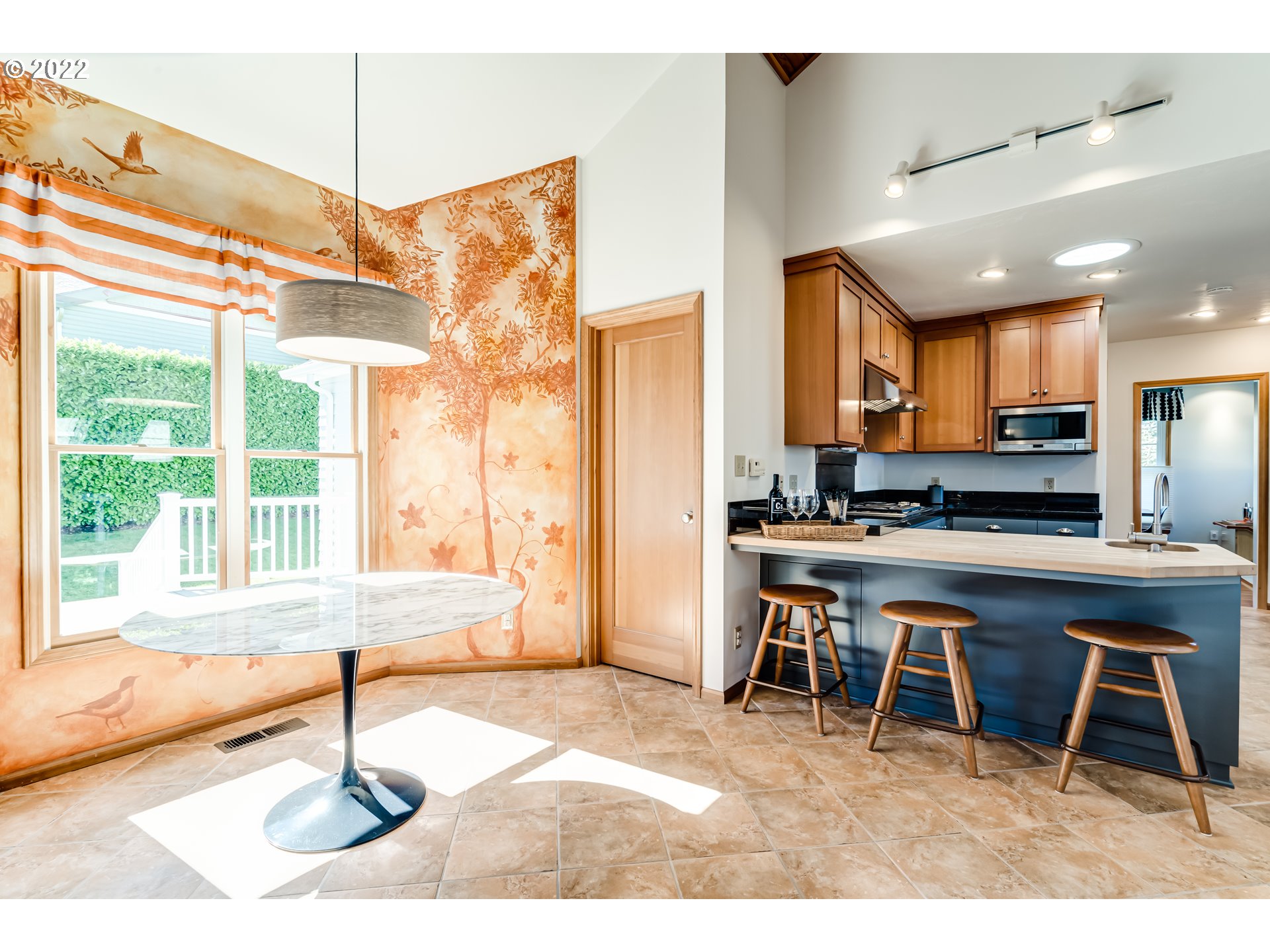 2059 Orchard Street Eugene, OR 97403 - Photo 12 of 32 a living room with a large window a table and chairs