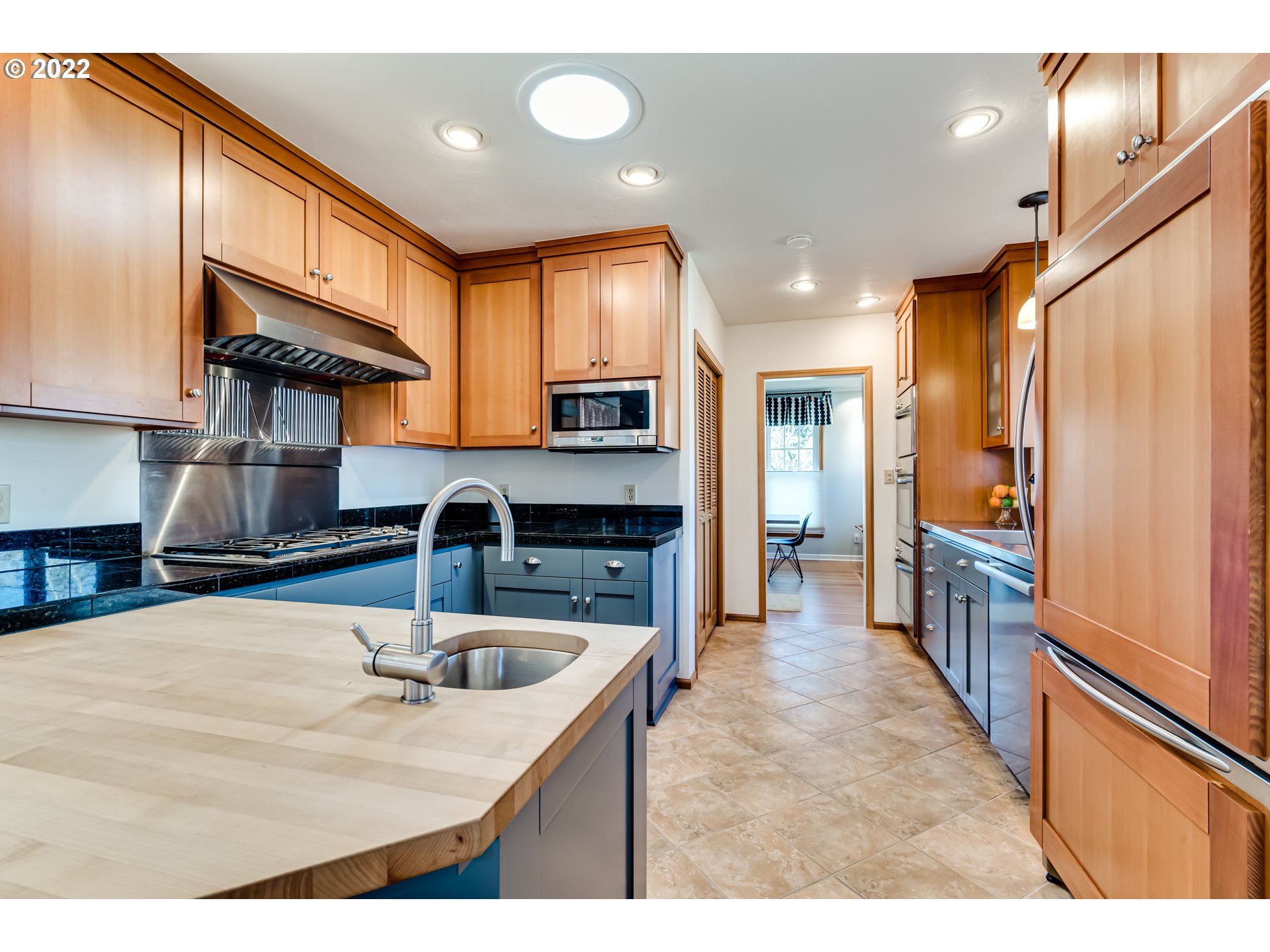 2059 Orchard Street Eugene, OR 97403 - Photo 9 of 32 a kitchen with stainless steel appliances granite countertop a sink refrigerator and cabinets