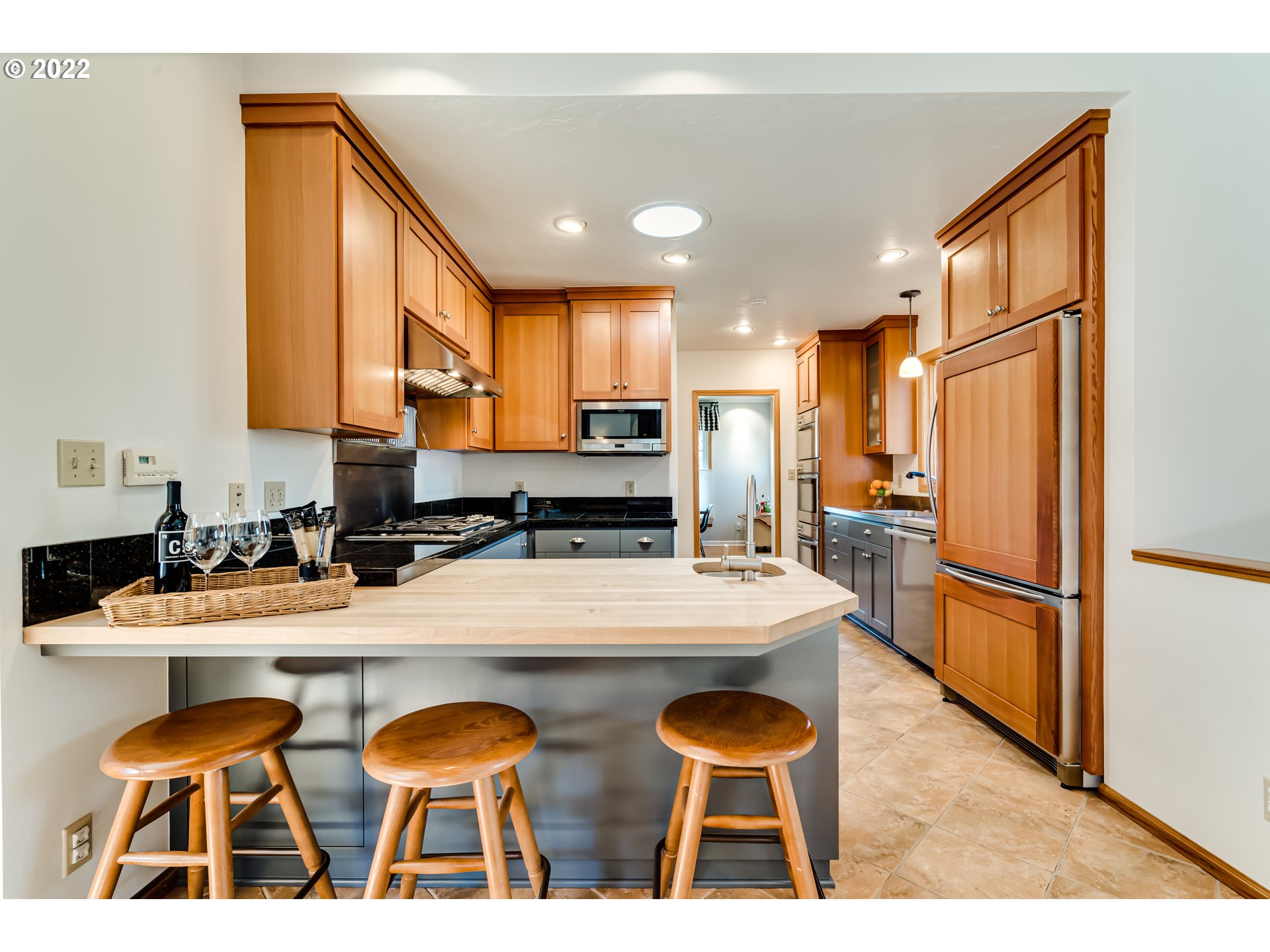 2059 Orchard Street Eugene, OR 97403 - Photo 10 of 32 a kitchen with stainless steel appliances granite countertop a sink refrigerator and cabinets