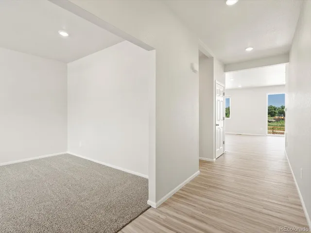 a view of a hallway with wooden floor