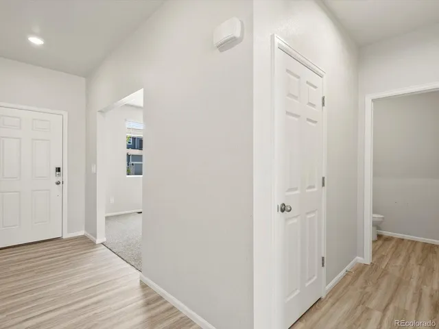 a view of a room with wooden floor
