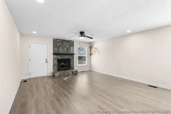wooden floor in an empty room with a fireplace
