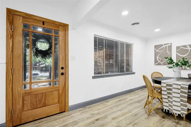 a dining room with furniture and wooden floor