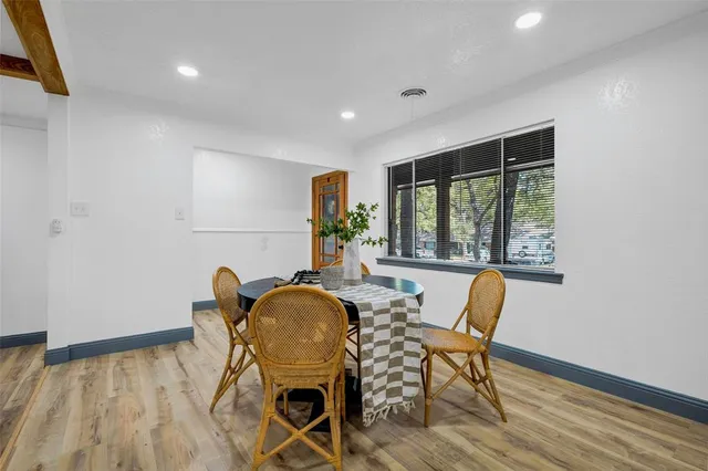 a dining room with furniture and window