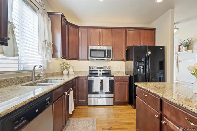 a kitchen with a sink stove and refrigerator